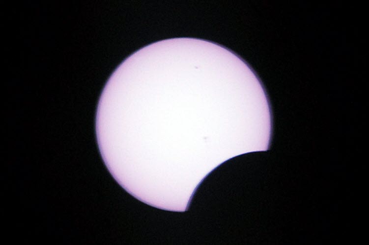 Cropped close-up through a big lens, shortly after eclipse began